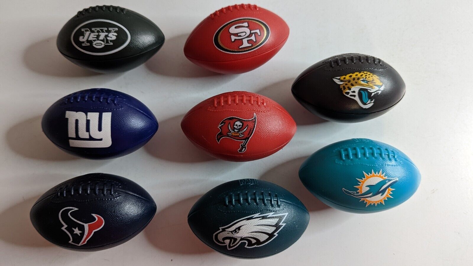 Lot of 8 NFL Football Teams Footballs 49'ers, Dolphins, Jets, Giants, Eagles Unbranded