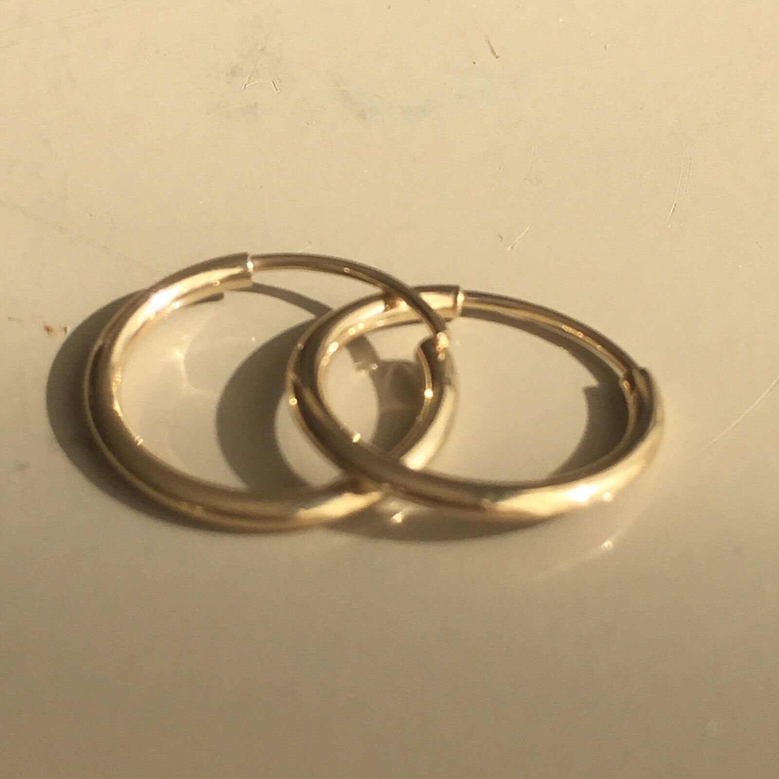 Pair of 10-11 mm, 14K Yellow Solid Gold Seamless Hoop Earrings marked 14K  Nobel Gems
